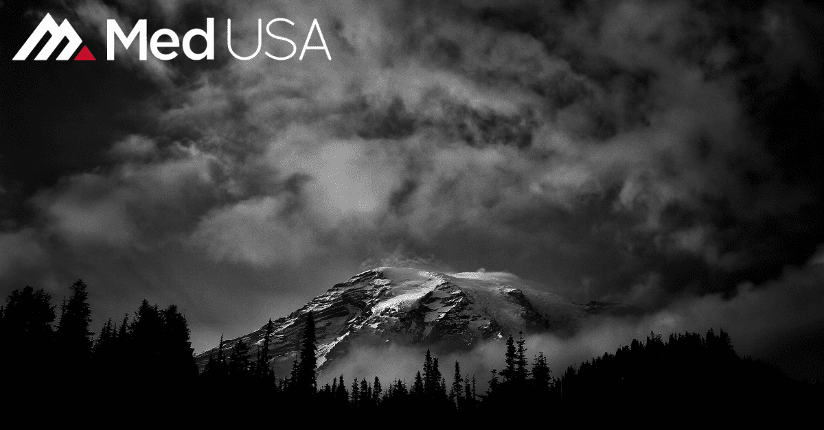 black and white image of forest and mountain with white and red Med USA logo