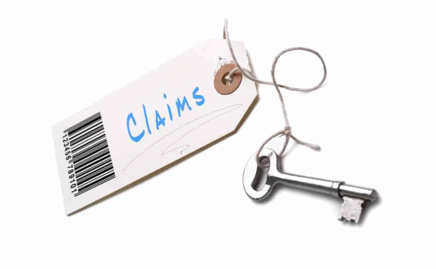 image of silver key with a white tag that says "claims" for medical billing fraud