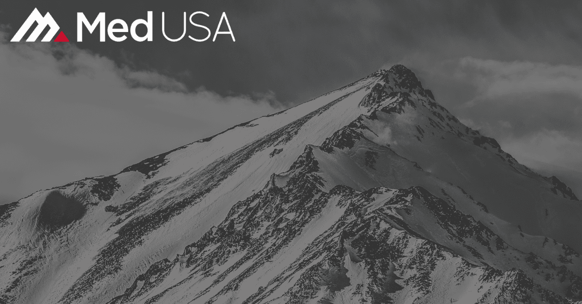 faded black and white image of mountain peak with white and red Med USA logo