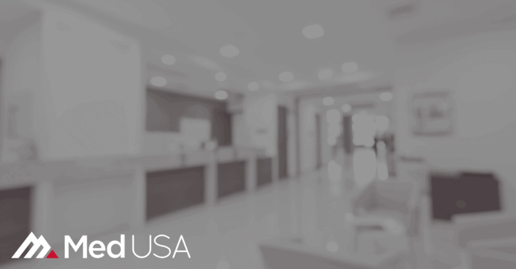 blurred black and white image of waiting room with white and red Med USA logo