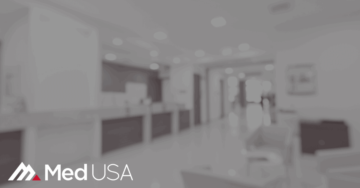 blurred black and white image of waiting room with white and red Med USA logo