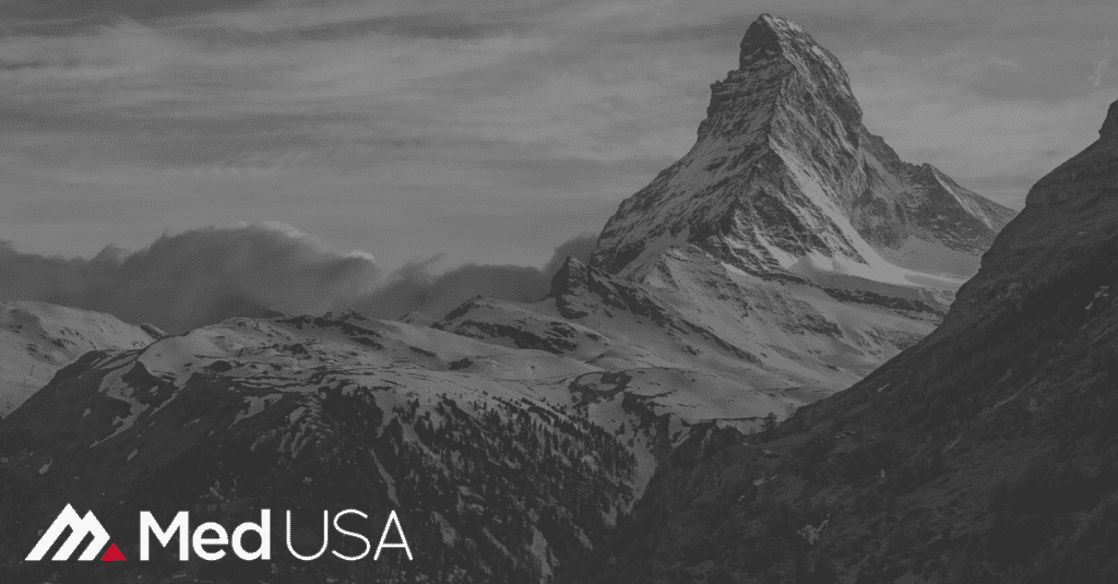image of peak of mountain in the clouds black and white with clouds and Med USA white and red logo