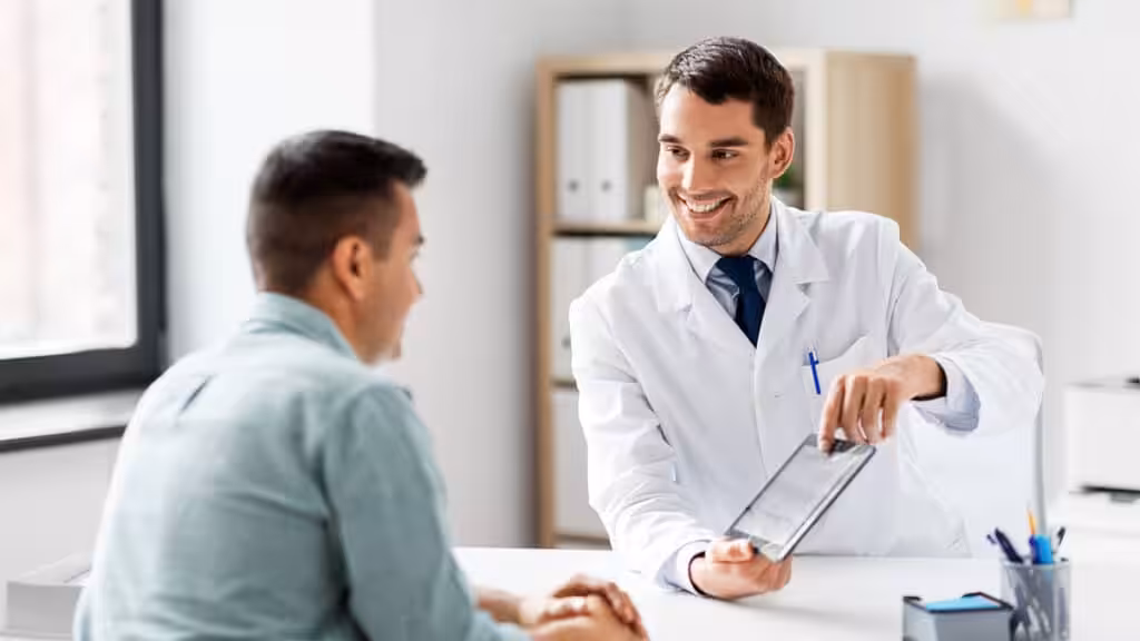 A healthcare provider showing a patient information on a tablet