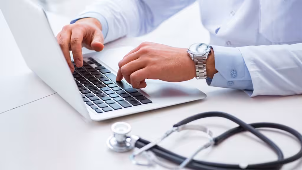 A doctor using a laptop