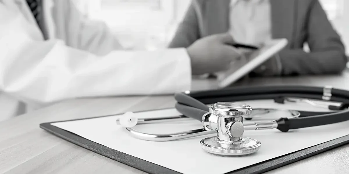 A doctor's stethoscope rests on a clipboard, symbolizing medical practice and patient care.