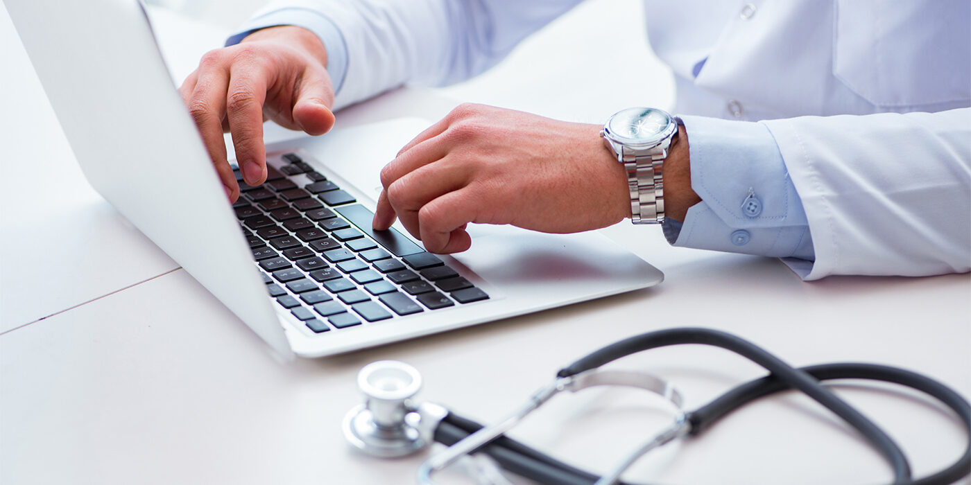 A doctor using a laptop