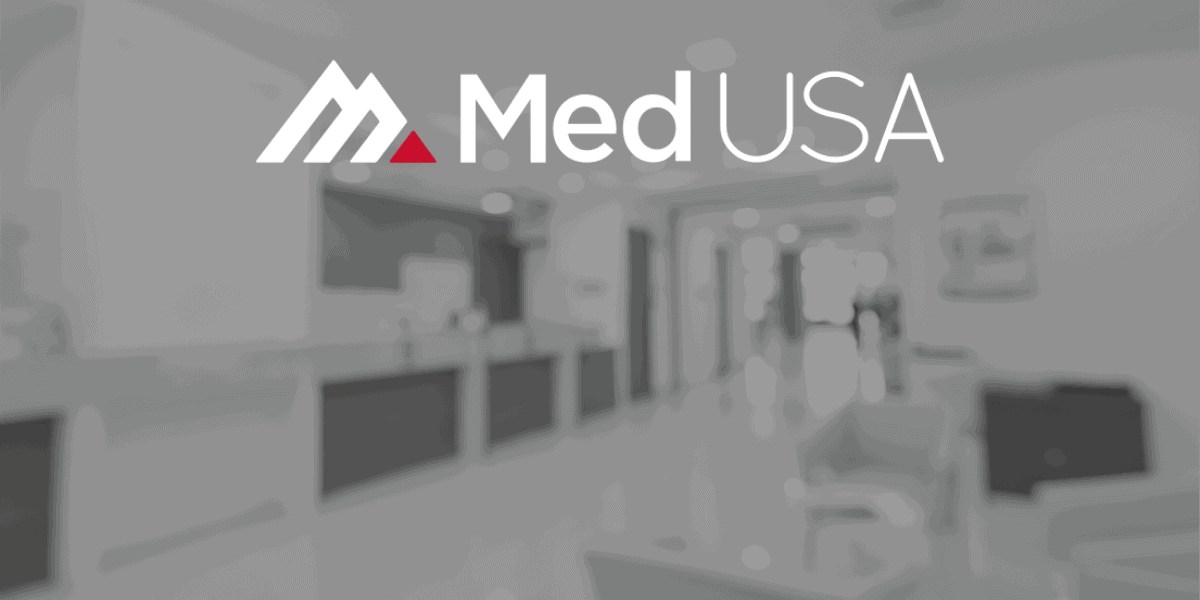 blurry background image of a medical practice outsourcing revenue cycle management with white and red med usa logo