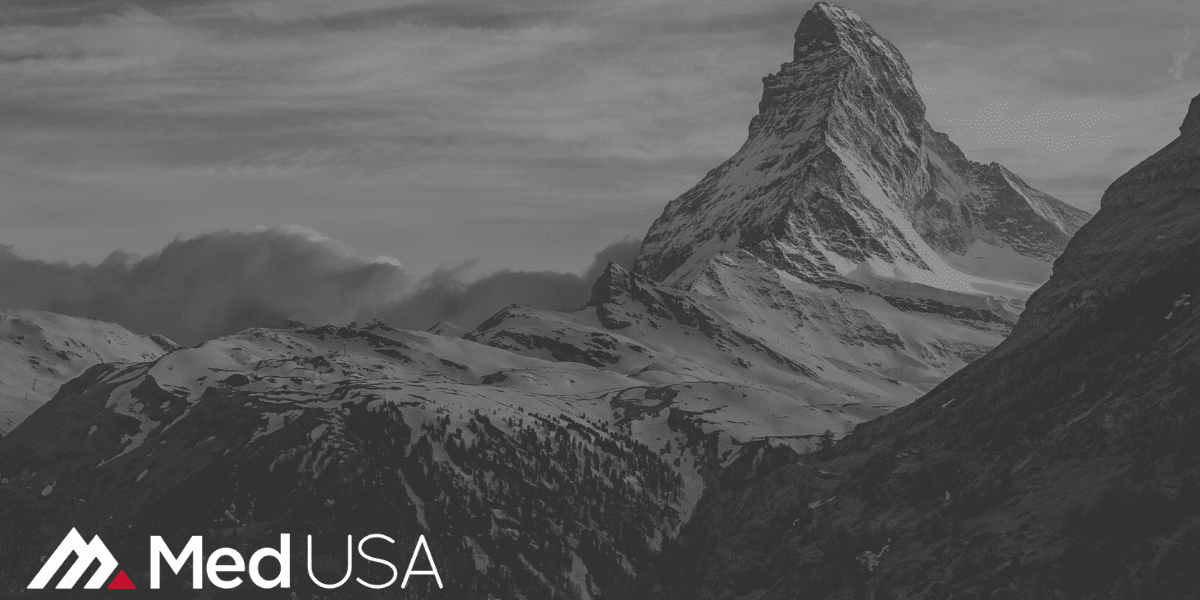 image of peak of mountain in the clouds black and white with clouds and Med USA white and red logo